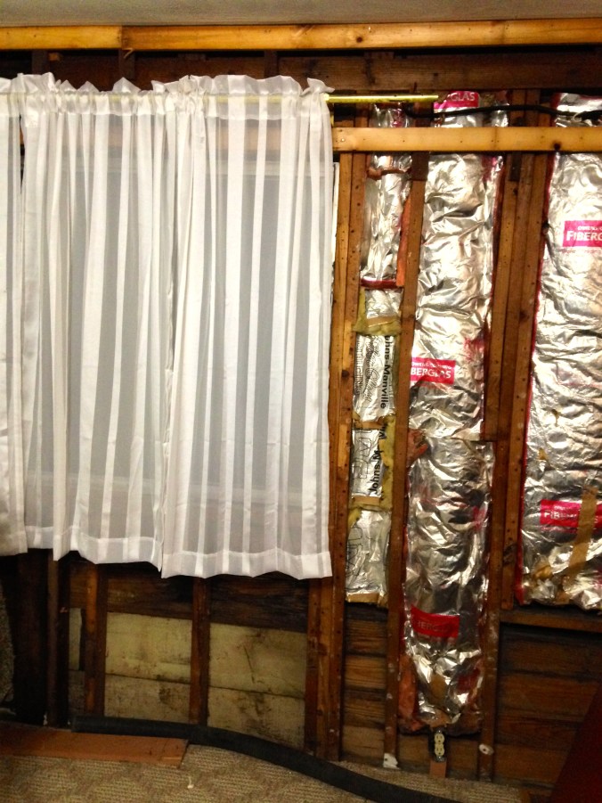 Lovely expensive sheers (K-mart special) hanging next to bare stud walls and insulation. Is this like leather and lace?