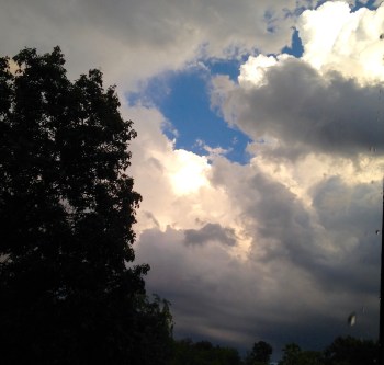 Blue sky behind gray clouds